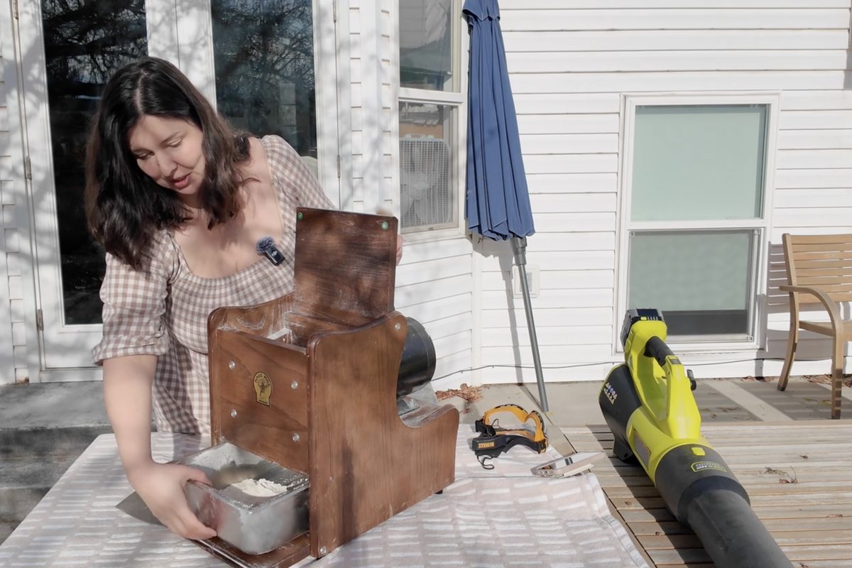 Module 6, Cleaning and Caring for Your Mill: cleaning a wooden grain mill outdoors